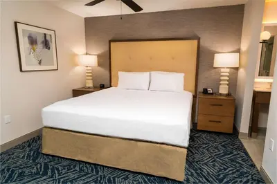 a large bed in a hotel room with two lamps at Homewood Suites By Hilton Rancho Cordova, Ca in Rancho Cordova