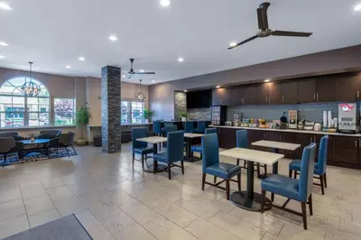 a restaurant with tables and chairs and a bar at Microtel Inn & Suites by Wyndham Tracy in Tracy