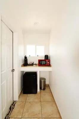 a small kitchen with a counter with a microwave at Sequoia Village in Three Rivers