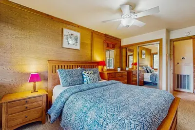 a bedroom with a bed and a ceiling fan at Northstar Condo with Forested Views in Truckee