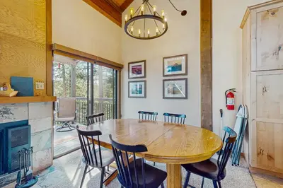 a dining room with a wooden table and chairs at Northstar Condo with Forested Views in Truckee