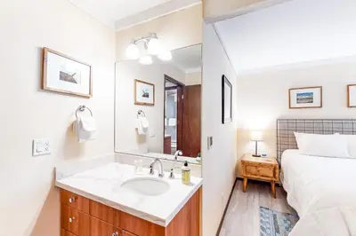 a bathroom with a sink and a bed at Sherwin Villas B13 in Mammoth Lakes