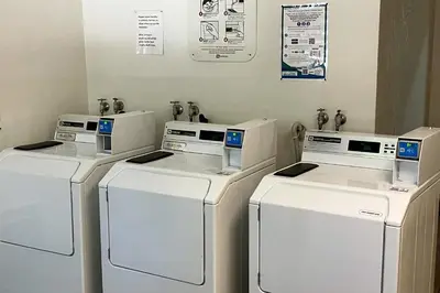 four washers and dryers are lined up in a room at Sherwin Villas B13 in Mammoth Lakes