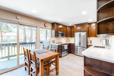 a kitchen with a table and chairs and a large window at Sherwin Villas B13 in Mammoth Lakes