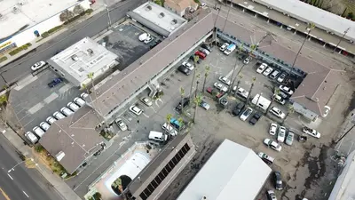 an overhead view of a parking lot with parked cars at Tiki Lodge Hotel Modesto in Modesto