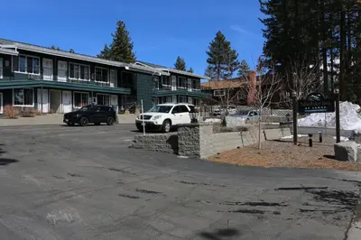 a parking lot with cars parked in front of a building at Bluelake Inn @ Heavenly Village in South Lake Tahoe