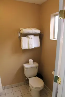 a bathroom with a white toilet and towels at Bluelake Inn @ Heavenly Village in South Lake Tahoe