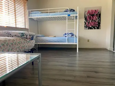 a room with two bunk beds and a couch at WHOLE Family - Wolfgram in Sacramento