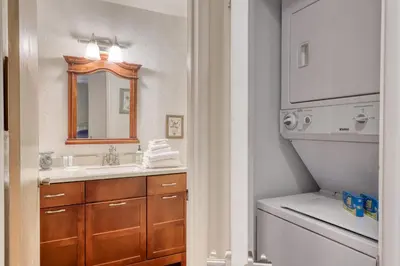 a bathroom with a sink and a washing machine at Bigwood 13 in Mammoth Lakes