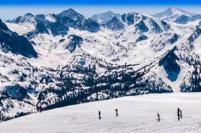a group of people skiing down a snow covered mountain at Bigwood 13 in Mammoth Lakes