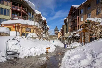 a street covered in snow next to buildings at Bigwood 13 in Mammoth Lakes