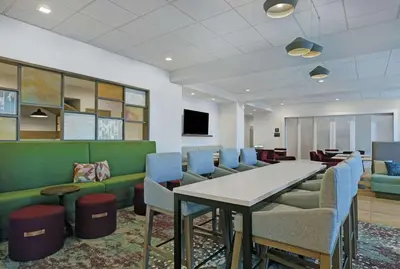 a waiting room with a table and chairs at Hampton Inn Patterson, Ca in Patterson