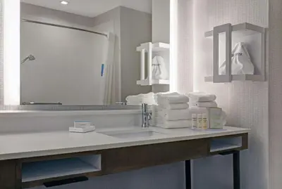 a bathroom with a sink and a mirror and towels at Hampton Inn Patterson, Ca in Patterson