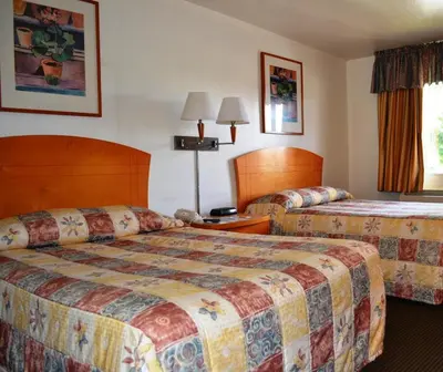 a hotel room with two beds in a room at Fresno Inn in Fresno