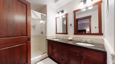 a bathroom with two sinks and a shower at Juniper Crest #7 Condo in Mammoth Lakes