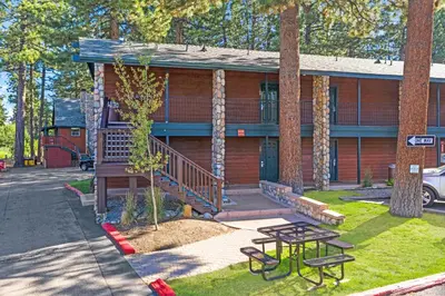 a house with a picnic table in front of it at 3 Peaks Resort & Beach Club in South Lake Tahoe