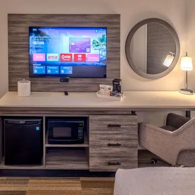 a living room with a tv and a couch and a chair at Hampton Inn & Suites South Lake Tahoe in South Lake Tahoe