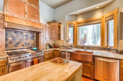 a kitchen with wooden cabinets and a wooden counter top at Bear Meadows Lodge - Hot Tub - Tahoe Donner Home in Truckee