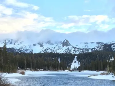 a view of a river with a mountain in the background at Mammoth Ski Racquet Club 115 in Mammoth Lakes