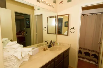 a bathroom with a sink and a mirror and towels at Mammoth Ski Racquet Club 82 in Mammoth Lakes