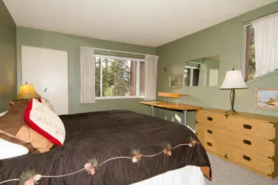 a bedroom with a bed and a desk and a window at Mammoth Ski Racquet Club 82 in Mammoth Lakes