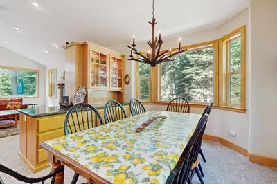 a dining room with a table and chairs at Agate Road Retreat in Carnelian Bay