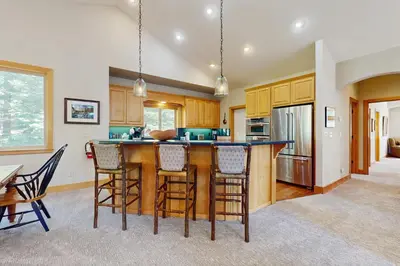 a kitchen with a large wooden island with bar stools at Agate Road Retreat in Carnelian Bay