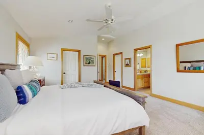 a bedroom with a white bed and a ceiling fan at Agate Road Retreat in Carnelian Bay