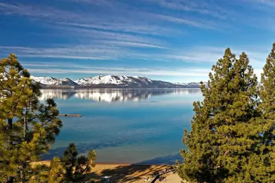 a view of a lake with snow covered mountains at The Landing Resort and Spa in South Lake Tahoe