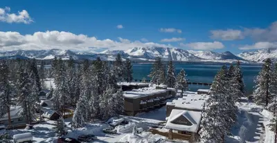 a view of a resort in the snow with mountains at The Landing Resort and Spa in South Lake Tahoe