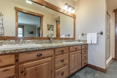 a bathroom with two sinks and a large mirror at Lodges 1132 - 3 bedroom Townhome on Golf Course in Mammoth Lakes