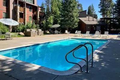 a large swimming pool with a metal rail in a yard at The Summit 5 in Mammoth Lakes
