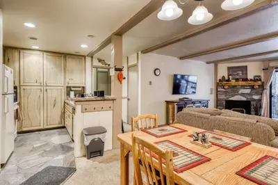 a kitchen and living room with a table and a couch at The Summit 5 in Mammoth Lakes