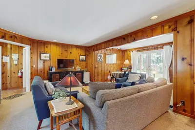 a living room with a couch and a tv at Casual and Cute Cabin Near the Lake in Tahoe Vista