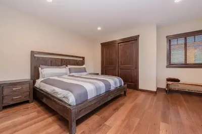 a bedroom with a large bed and a wooden floor at Mountainside 4 in Mammoth Lakes