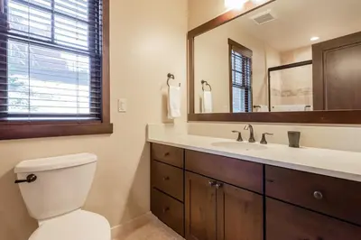 a bathroom with a toilet and a sink and a mirror at Mountainside 4 in Mammoth Lakes