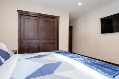 a bedroom with a bed and a wooden door at Mountainside 5 in Mammoth Lakes