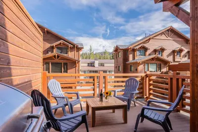a patio with chairs and a table on a deck at Mountainside 5 in Mammoth Lakes
