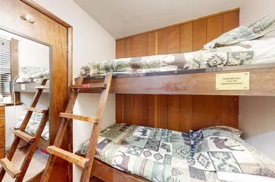 a bedroom with two bunk beds and a mirror at Horizons 4 143 in Mammoth Lakes