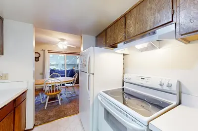 a kitchen with a white refrigerator and a dining room at Horizons 4 143 in Mammoth Lakes