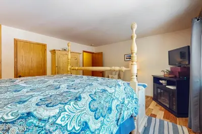 a bedroom with a bed with a blue and white bedspread at Tastefully-Updated, Classic Tahoe Family Home in Truckee