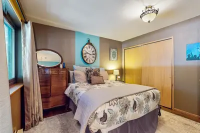 a bedroom with a bed and a clock on the wall at Tastefully-Updated, Classic Tahoe Family Home in Truckee