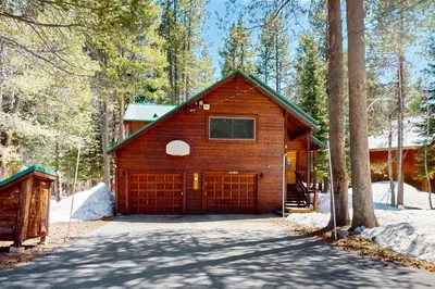 a house with a garage in the woods at Tastefully-Updated, Classic Tahoe Family Home in Truckee