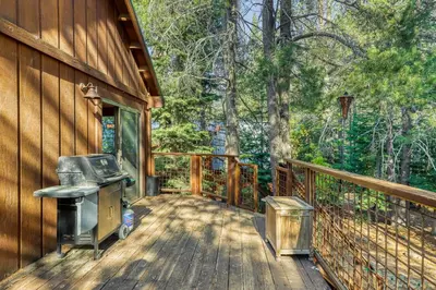 a wooden deck with a grill on the side of a house at Tastefully-Updated, Classic Tahoe Family Home in Truckee