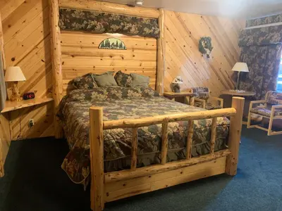 a bedroom with a bed in a wooden room at Tahoe Valley Lodge in South Lake Tahoe