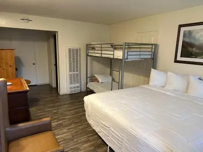 a bedroom with a bed and bunk beds in it at Big Pines Mountain House in South Lake Tahoe