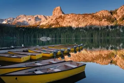 a group of boats sitting in the water at 1849 #308 in Mammoth Lakes