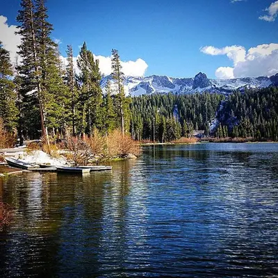 a lake with a boat in the middle of it at Juniper Springs Lodge #238 in Mammoth Lakes