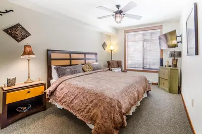 a bedroom with a bed and a ceiling fan at White Mountain Lodge #2329 in Mammoth Lakes