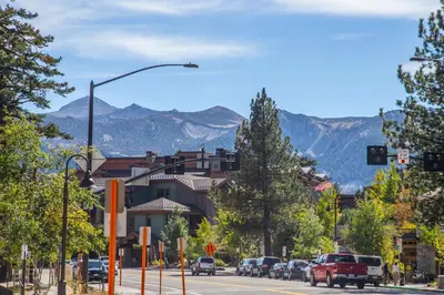 a city street with a street light and mountains in the background at White Mountain Lodge #2329 in Mammoth Lakes